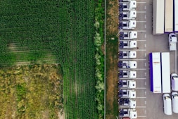 parked vehicles on parking lot near plant field