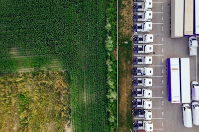 parked vehicles on parking lot near plant field