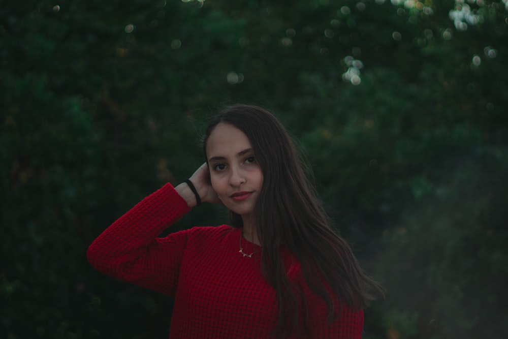 woman smiling near trees