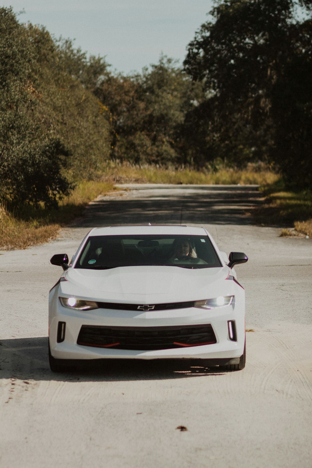 white coupe on road