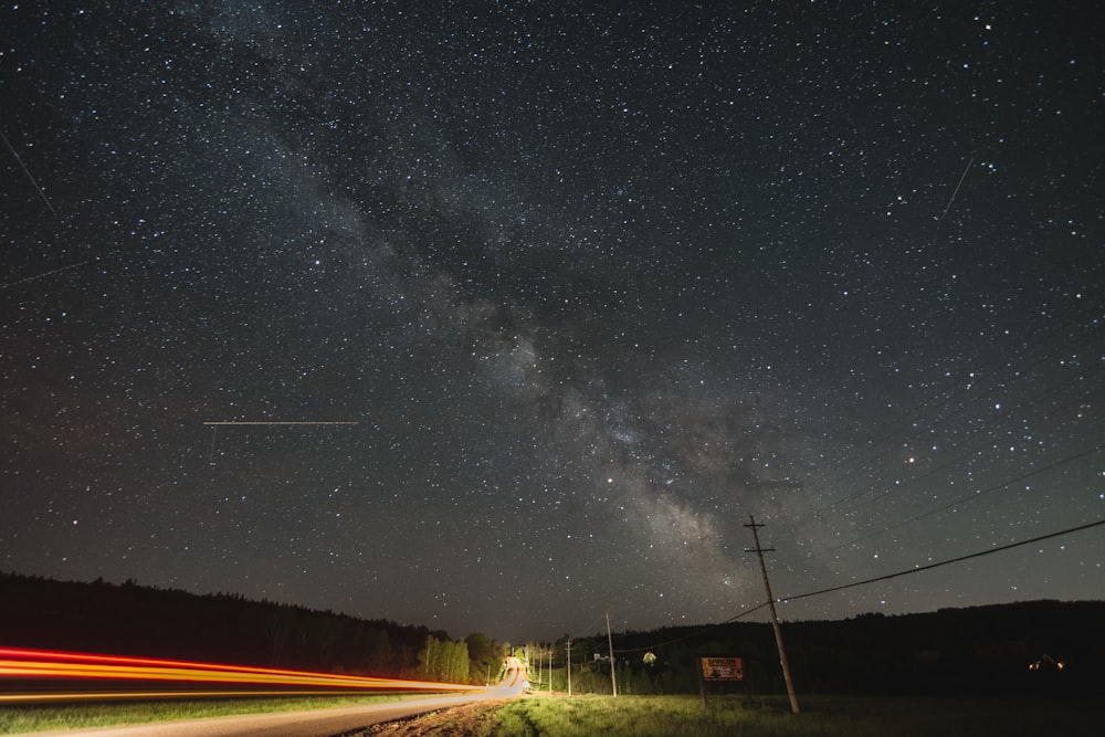 long exposure of vehicles and milky way galaxy