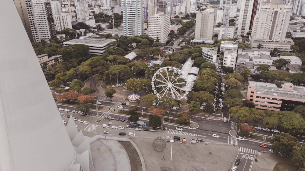 white Ferris wheel beside building