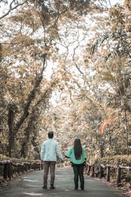 A couple holding hands in a serene outdoor setting, symbolizing love and connection.