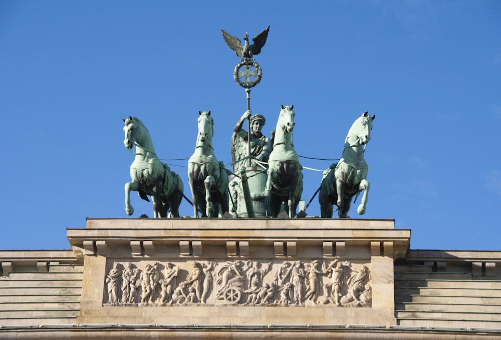 man riding on carriage statue