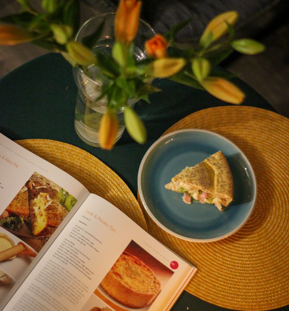 a plate with a slice of pie on it next to a book