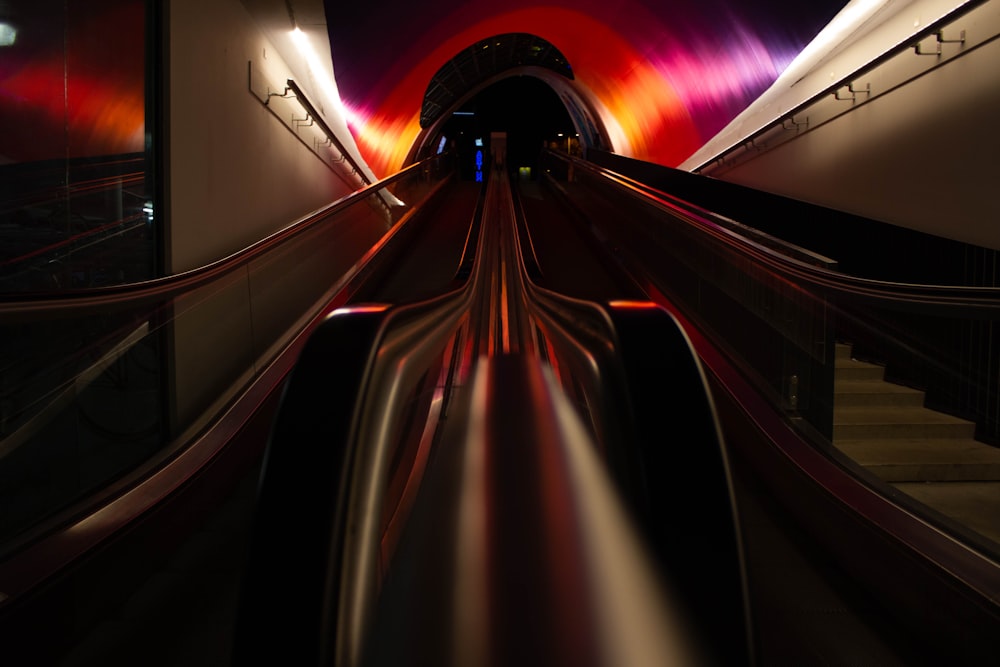 a long exposure photo of a train going through a tunnel