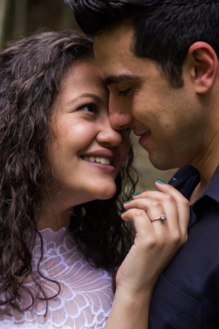 A candid moment of a couple sharing a quiet smile during their engagement session in Somerville.