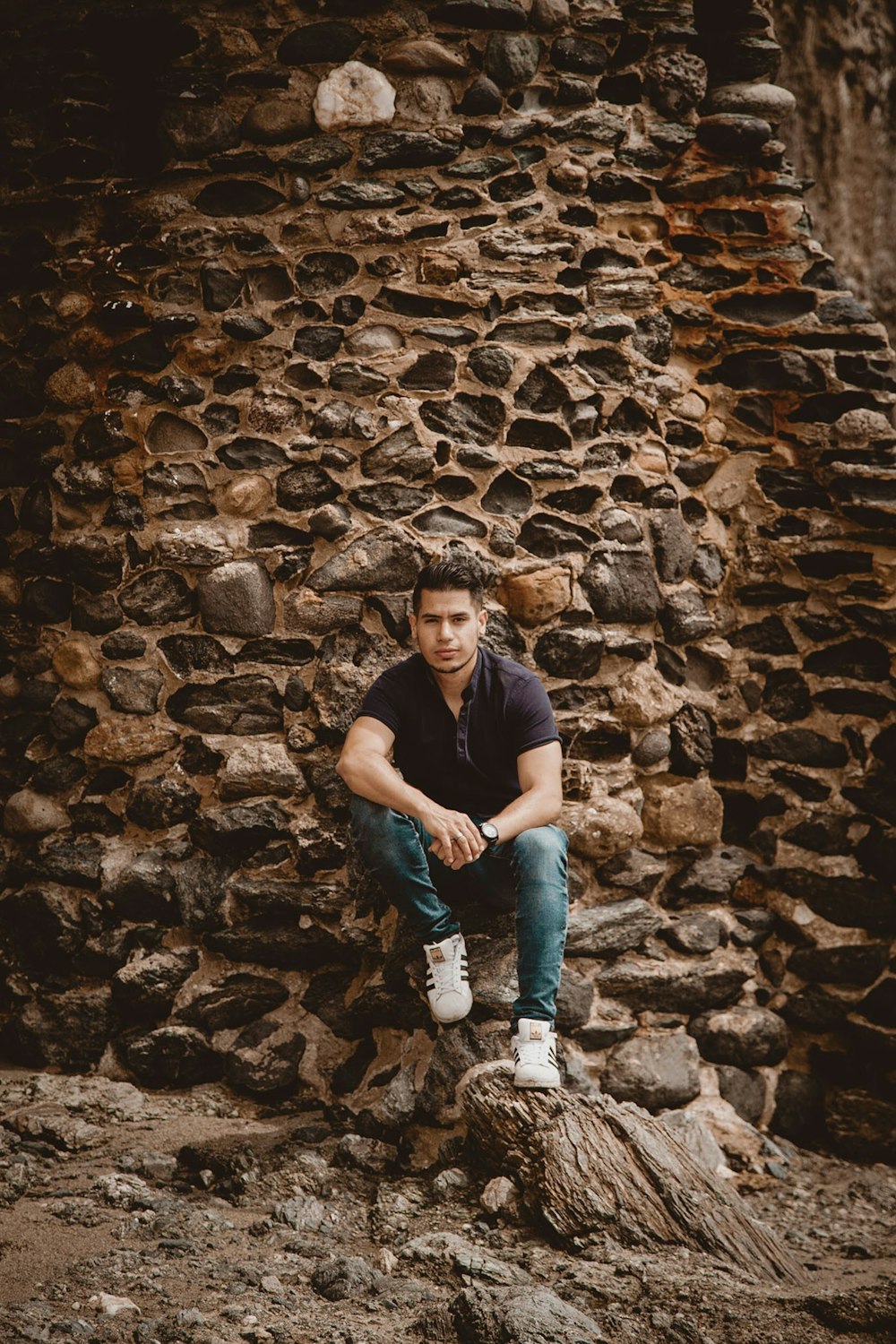 man sitting on stone