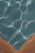 A section of a swimming pool with clear blue water, showing the grid pattern of the pool tiles. Sunlight casts bright, wavy reflections across the water's surface. The image features the pool’s corner with a contrasting tan edge.