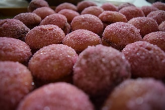Close-up of delicate pink confectionery cutters arranged on a pastel surface.