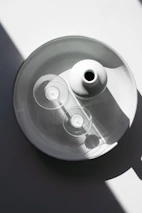 A minimalist arrangement of Auria candles with subtle shadows and soft golden accents.