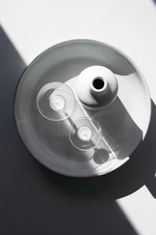 A minimalist arrangement of Auria candles with subtle shadows and soft golden accents.