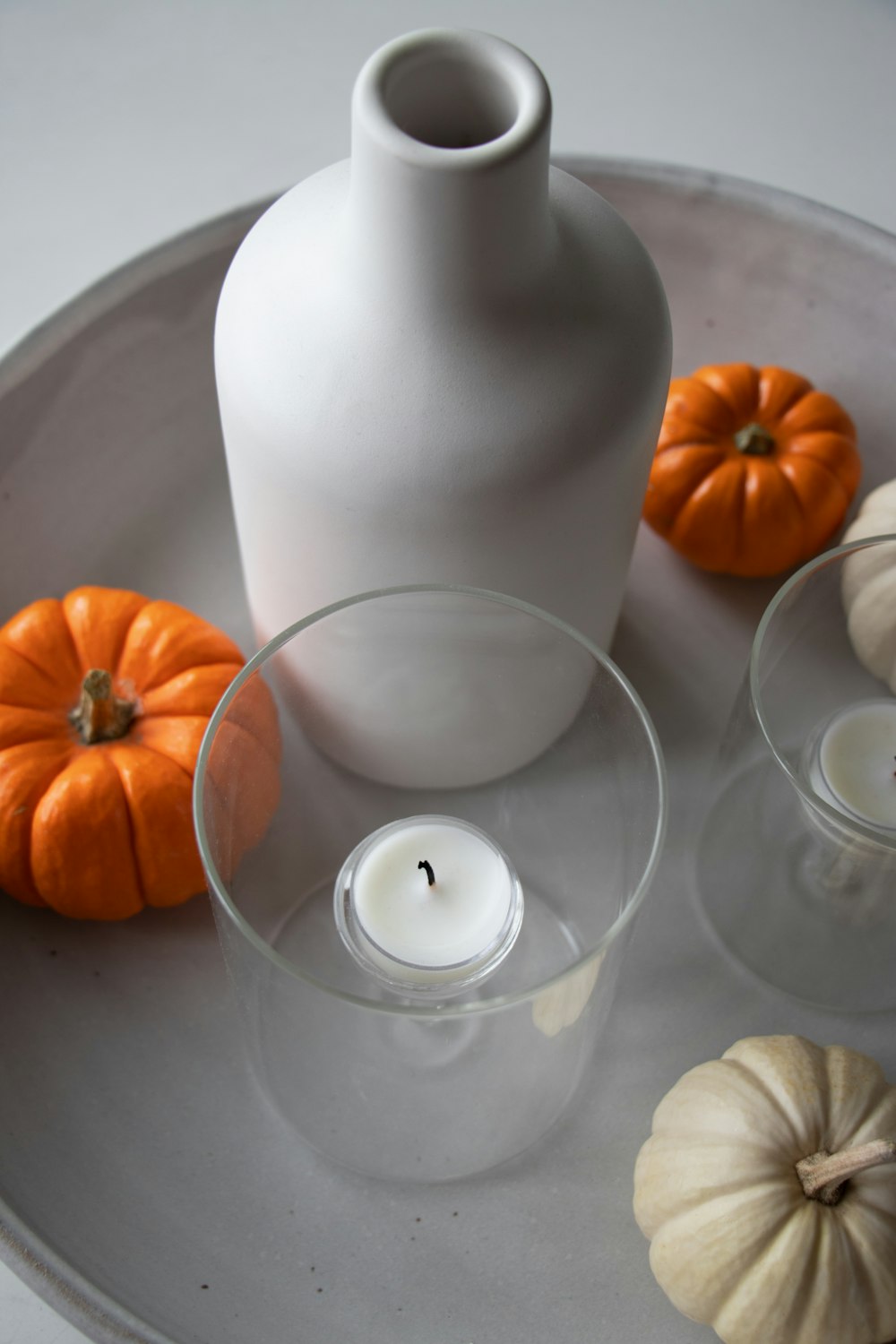 white tealight near white ceramic vase