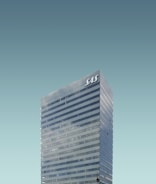 A tall, modern skyscraper with reflective windows and the letters 'SAS' displayed at the top. The building stands against a clear, cloudless sky.