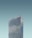 A tall, modern skyscraper with reflective windows and the letters 'SAS' displayed at the top. The building stands against a clear, cloudless sky.
