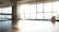 A serene studio corner with soft natural light highlighting a reformer pilates machine and a peaceful plant nearby.
