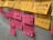 A collection of sticky notes are attached to a wall. Yellow and pink notes feature handwritten text in French. Some phrases are stressed, indicating important points or concerns.