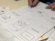 A designer sketching colorful app screens on a digital tablet.