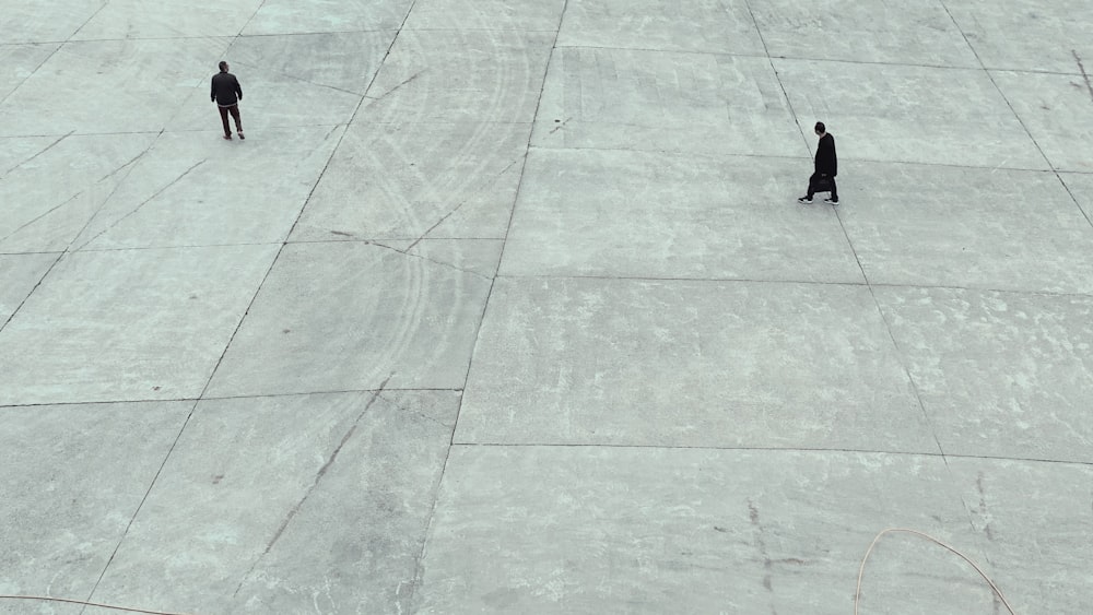 two men standing on white tiles