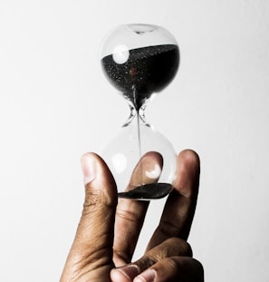 person holding hourglass