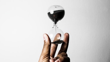 person holding hourglass
