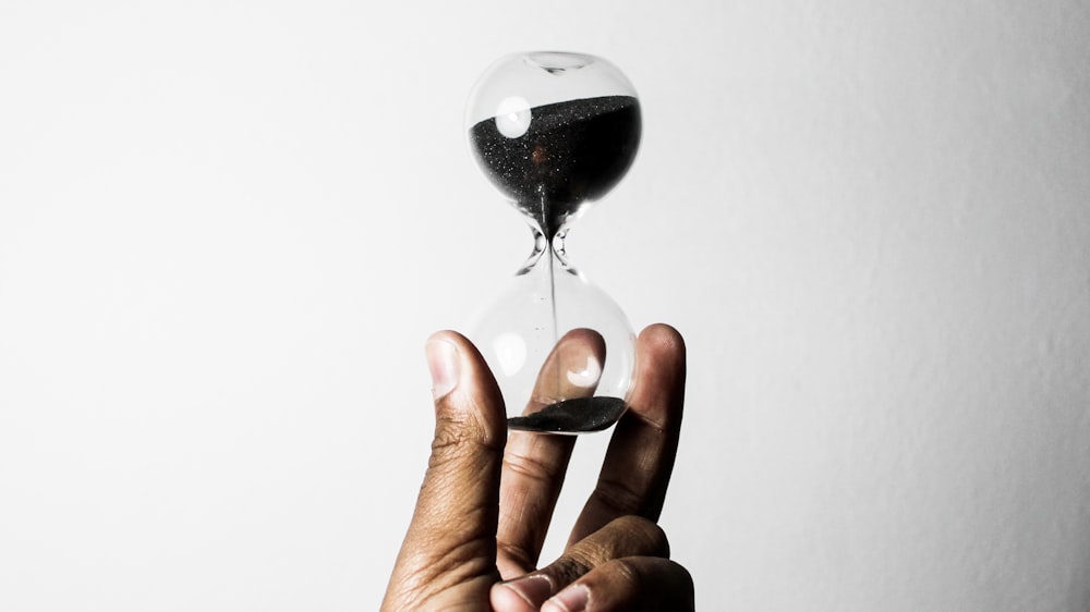 person holding hourglass