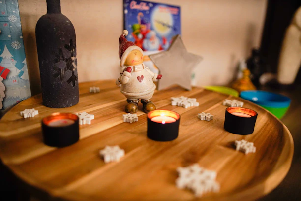 A cozy holiday scene featuring Ken Bailey Gifts products displayed on a rustic wooden table with twinkling lights.