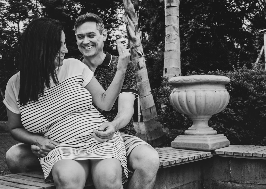 greyscale photo of smiling man and woman