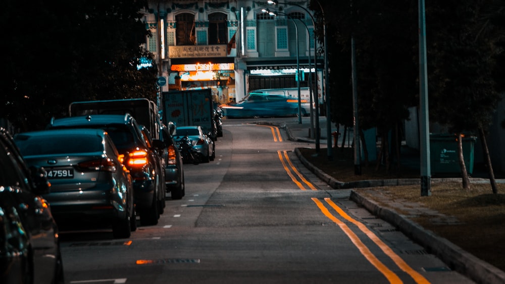 photography of vehicles parked beside road during daytime