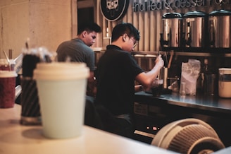 A friendly customer service representative wearing a headset, ready to assist with bulk beverage orders.
