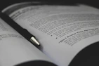 An open workbook showing clear handwriting, grammar exercises, and marked improvements.
