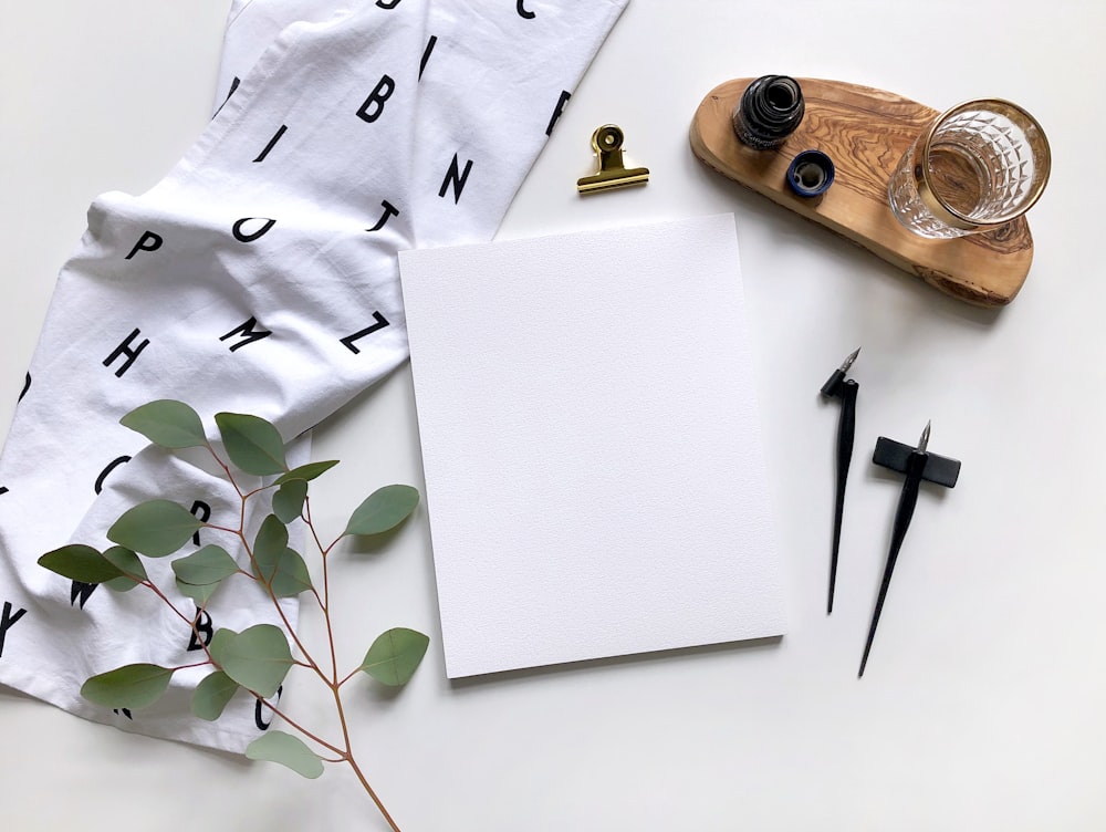 white paper beside leaf