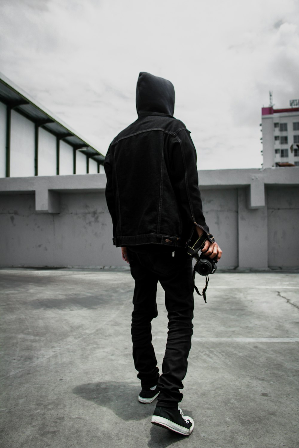 man wearing black hooded jacket