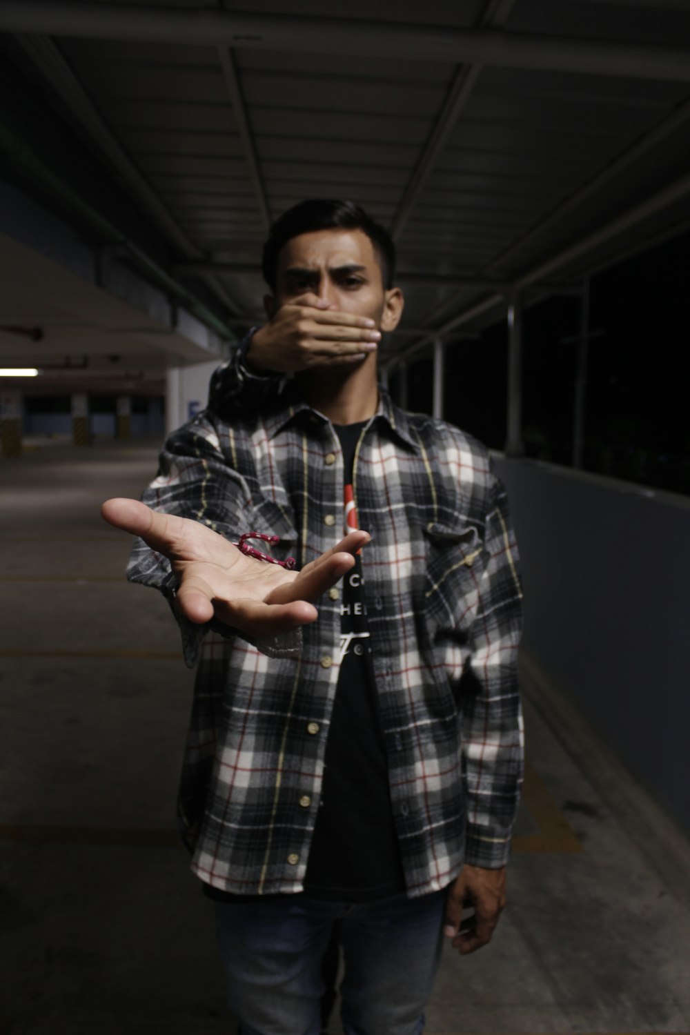 man wearing grey and black plaid dress shirt