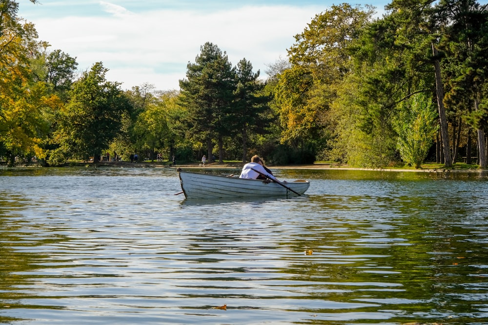 photography of person riding boat during daytime