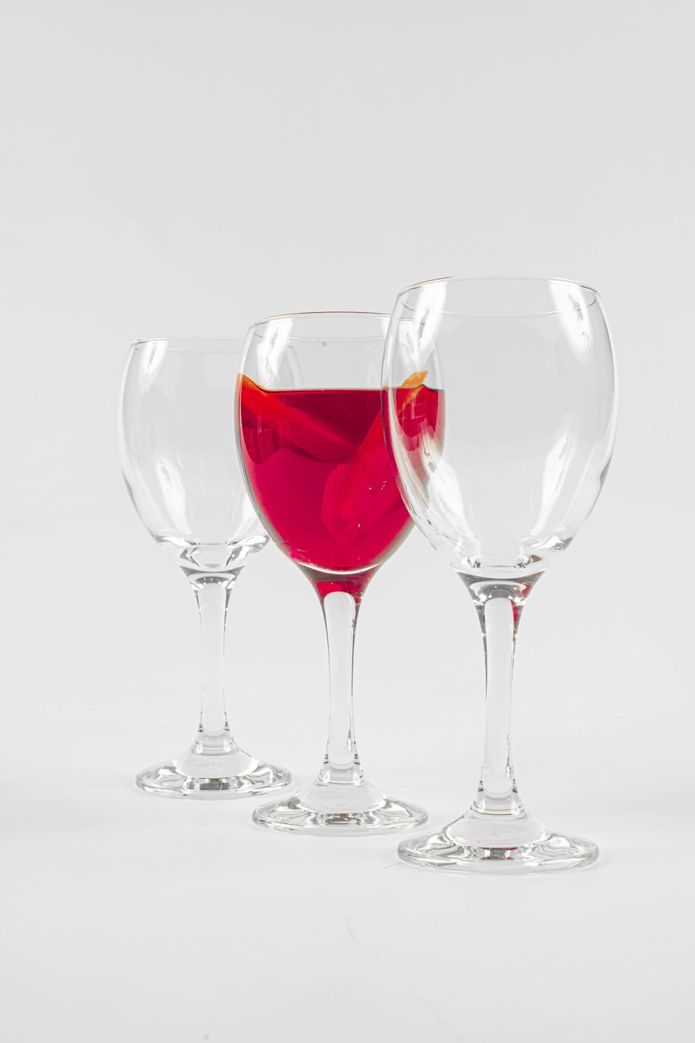 three clear glass wine glasses