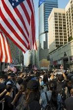 A vibrant crowd gathered outside Independence Hall in Philadelphia, waving CDC-USA flags with enthusiasm.