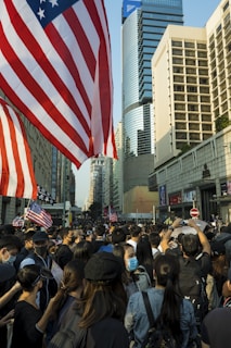A vibrant crowd gathered outside Independence Hall, waving CDC-USA flags under a bright blue sky.