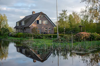 Country house by the trees and water