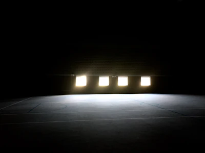 Modern indoor sports flooring installation in a gymnasium with natural light.
