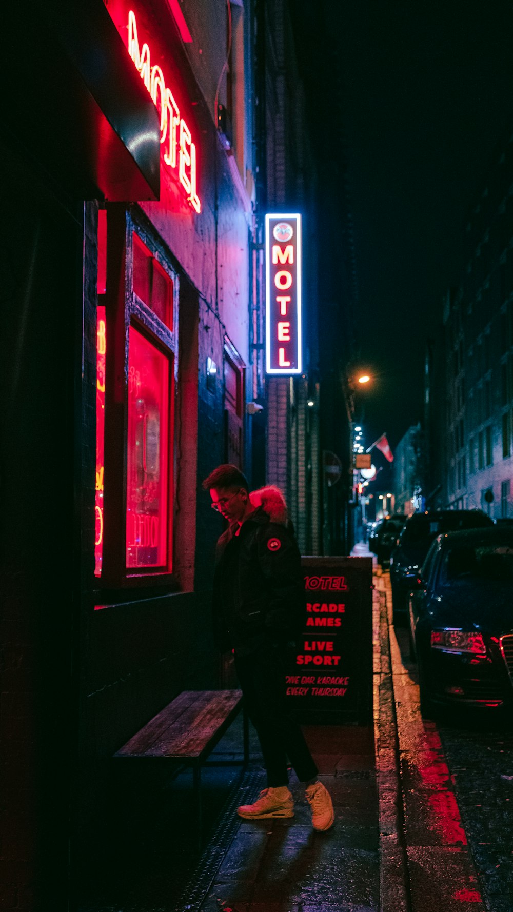 man standing beside motel