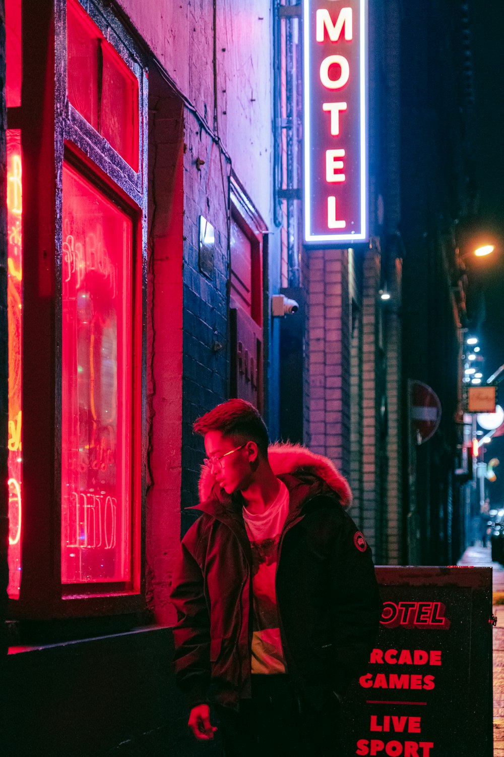 a man sitting on a bench in front of a motel