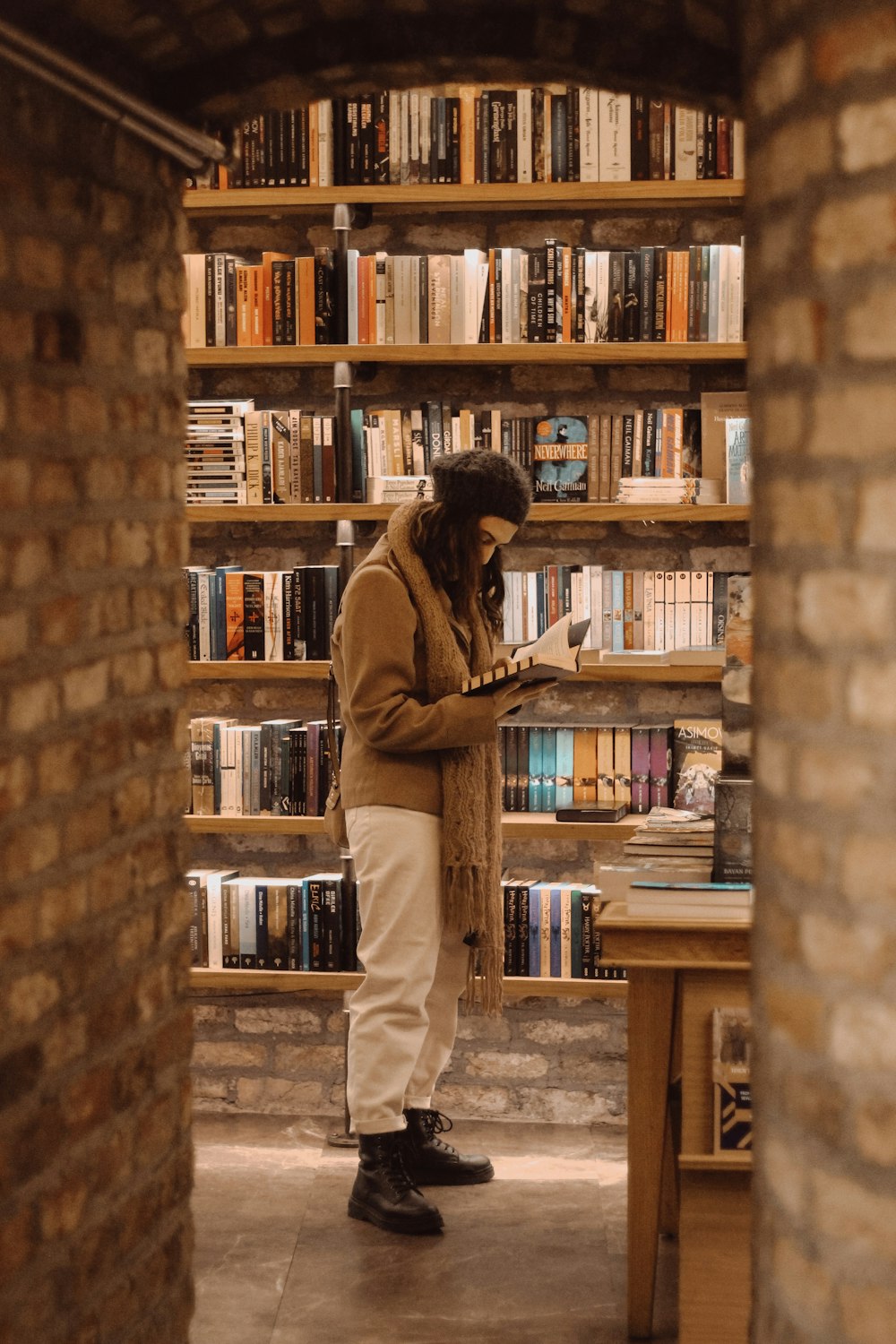 woman wearing brown scarf reading book