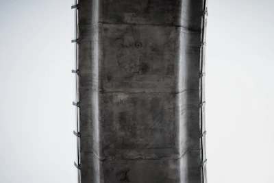 Close-up of fiber optic sensors installed on a concrete bridge structure.