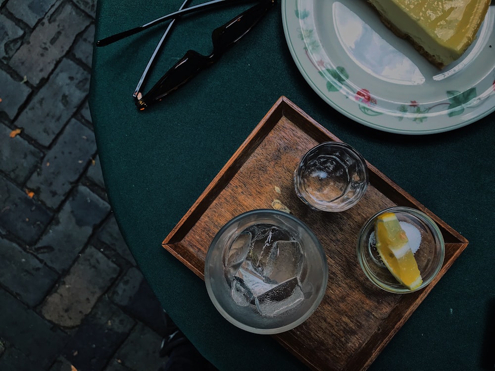 a slice of pie and two glasses of water on a table