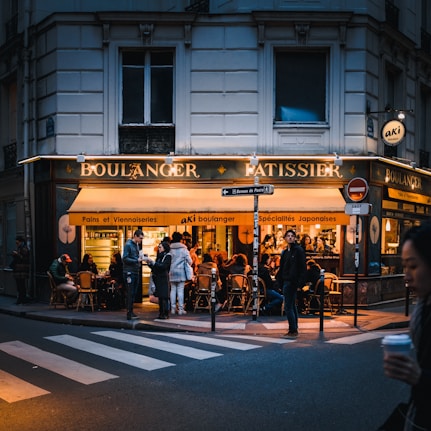 people in front and in Boulanger Ratissier shop during night