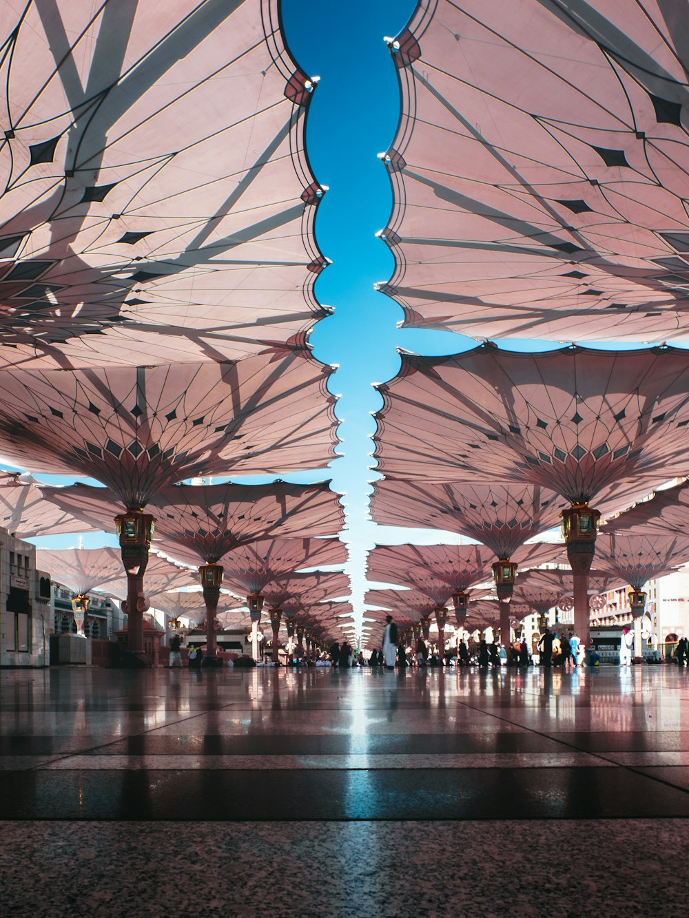 people walking between umbrellas during daytime