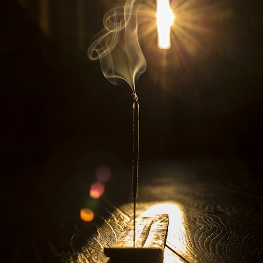 A serene image of frankincense resin burning, emitting calming smoke.