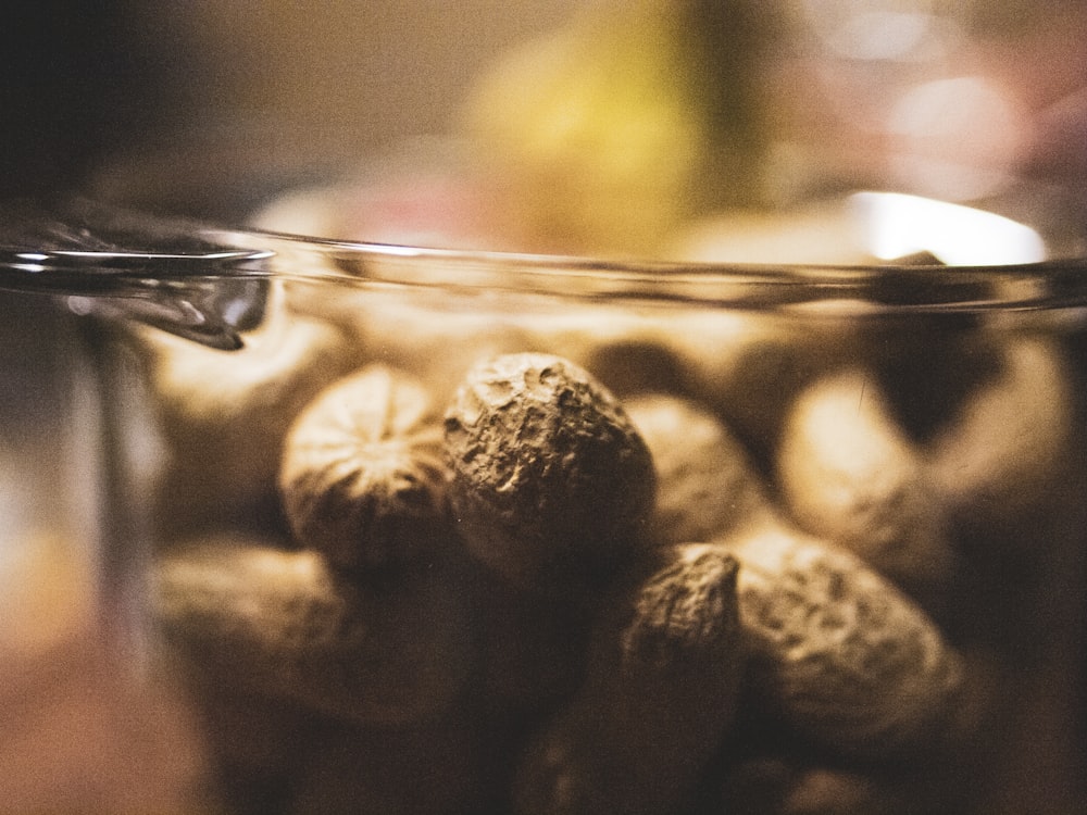 photo of brown nuts on glass food container