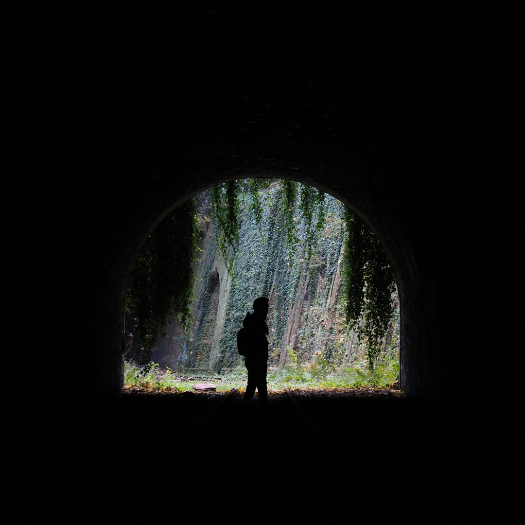 person standing in tunnel